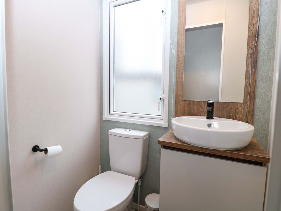 A bathroom with a toilet and sink at Caravan in Great Yarmouth