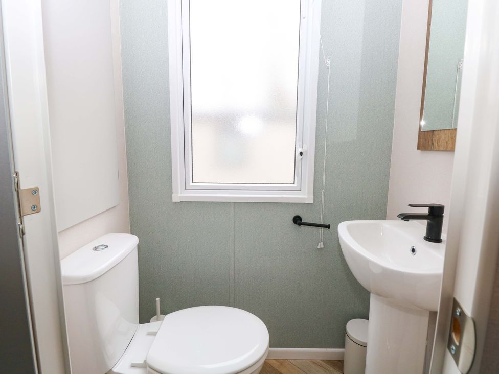 A bathroom with a toilet and sink at Caravan in Great Yarmouth