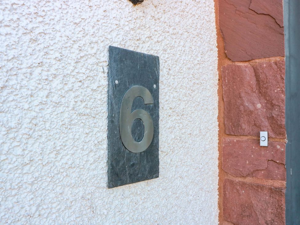 A number 6 plaque mounted on a wall at Ledrishmore View in Alexandria