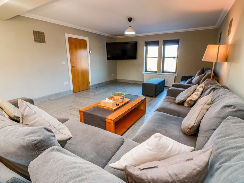 A living room with a sofa and coffee table at Ledrishmore View Alexandria