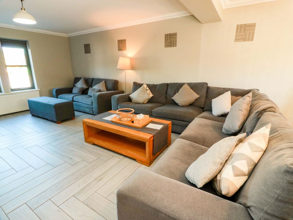A living room with sofas and a coffee table at Ledrishmore View Alexandria
