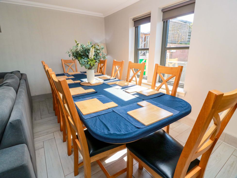 A dining room with a large table and seating at Ledrishmore View Alexandria