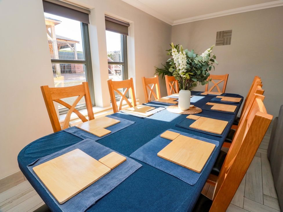 A dining room with a table set for meals at Ledrishmore View Alexandria