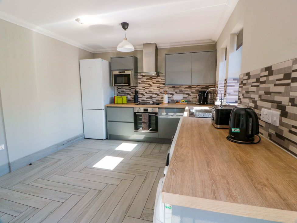 A kitchen with appliances and cabinets at Ledrishmore View in Alexandria