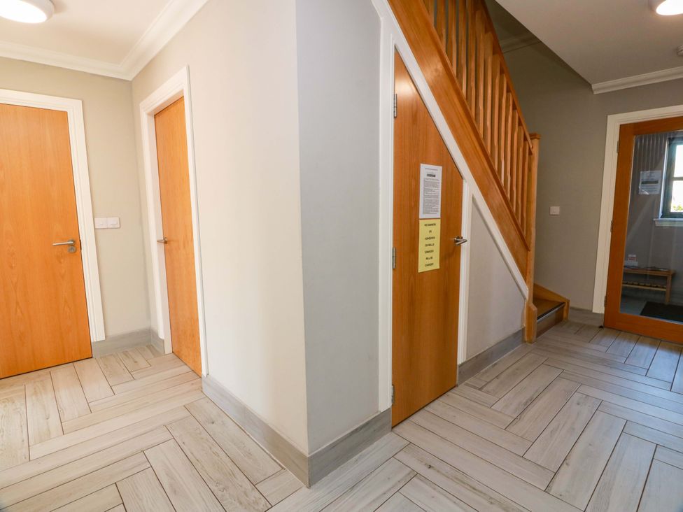 A hallway with stairs and multiple doors at Ledrishmore View Alexandria