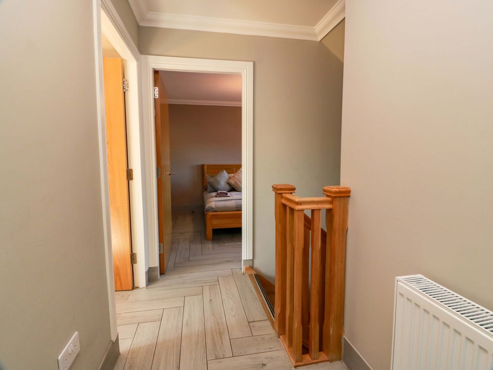 A hallway with a door and bed visible at Ledrishmore View Alexandria