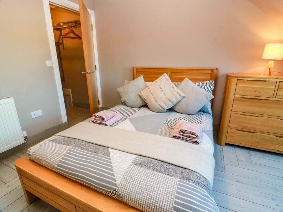 A bedroom with a bed and dresser at Ledrishmore View in Alexandria