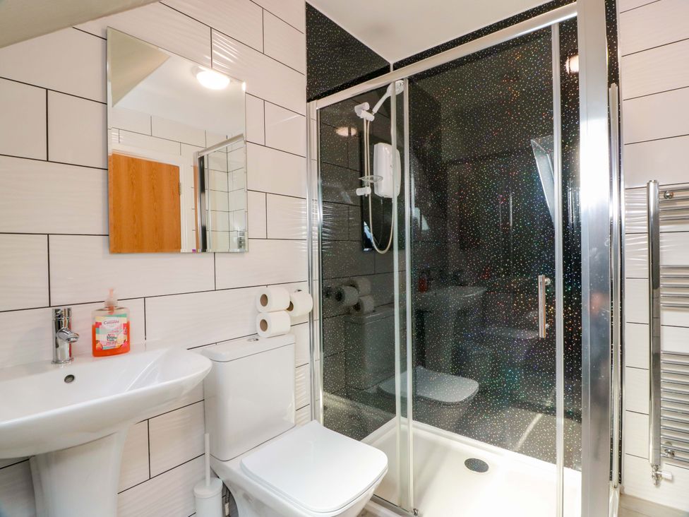 A bathroom containing a sink, toilet, shower, and mirror at Ledrishmore View in Alexandria
