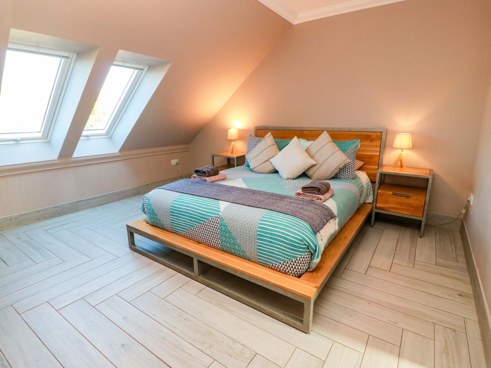 A bedroom with a bed and nightstand at Ledrishmore View in Alexandria