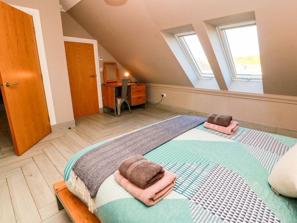 A bedroom with a bed and desk at Ledrishmore View in Alexandria