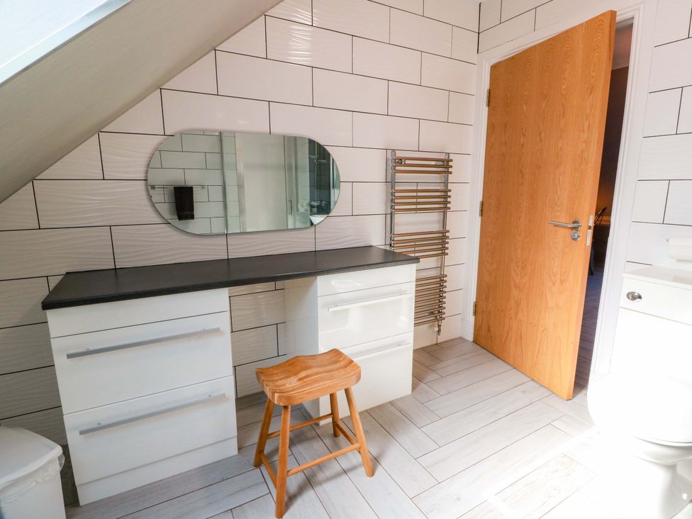 A bathroom with a mirror and a vanity unit at Ledrishmore View Alexandria