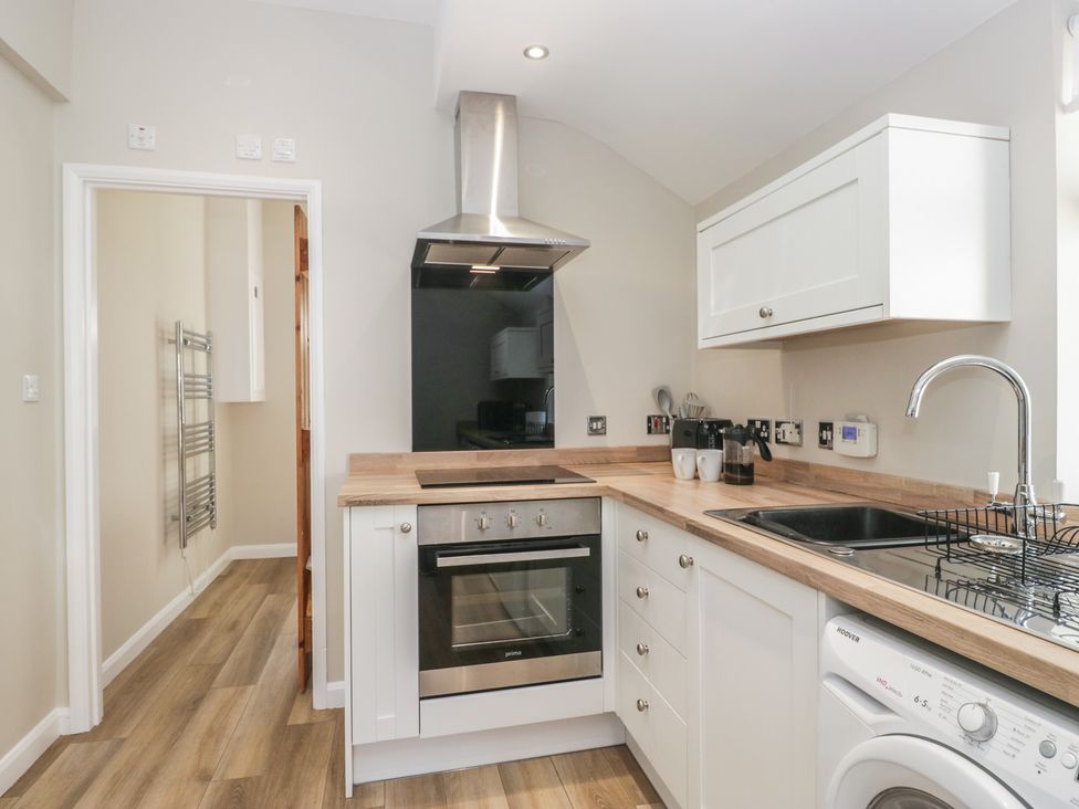 A kitchen with an oven and sink at Fellfoot Cottage