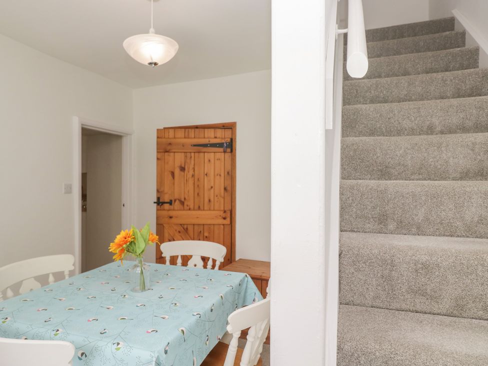 A dining room with a table and chairs at Fellfoot Cottage