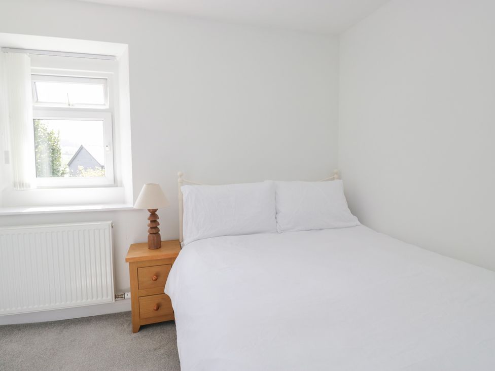 A bedroom with a bed and lamp at Fellfoot Cottage