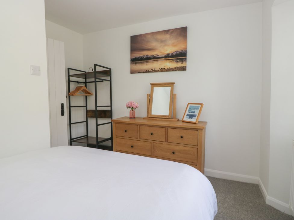 A bedroom with a dresser and mirror at Fellfoot Cottage
