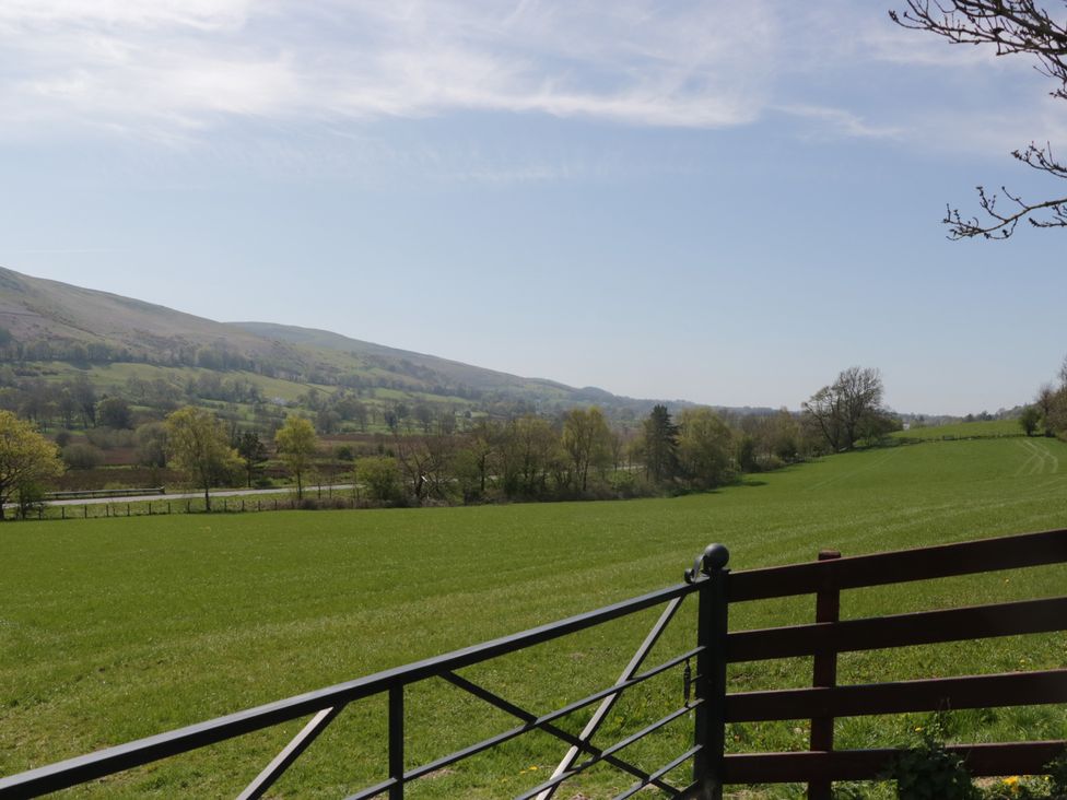 A view of fields and mountains with a gate at Fellfoot Cottage