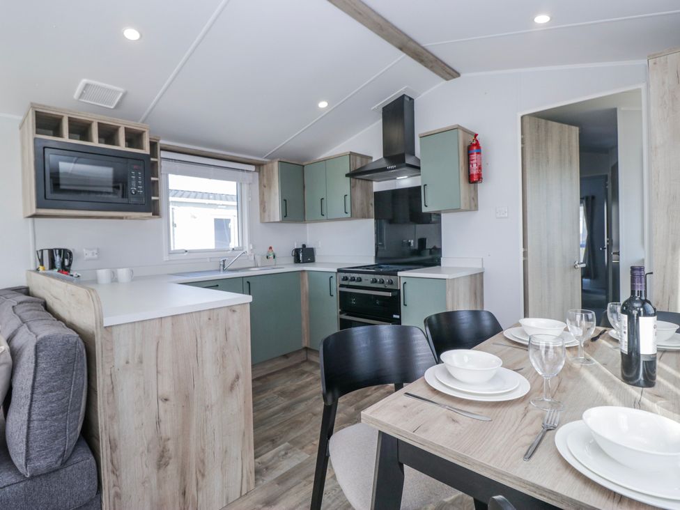 A kitchen with a dining table set at Willerby High End Brand S6 (on Coniston) St Bees