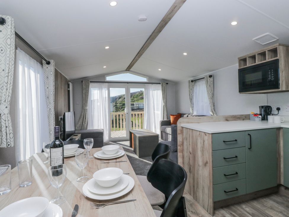 A living room with a dining area and kitchen features at Willerby High End Brand S6 (on Coniston) St Bees
