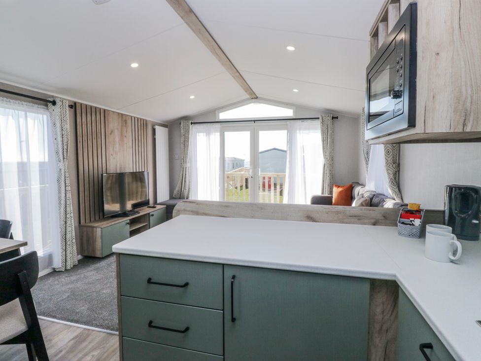 A living room with a television and sofa at Willerby High End Brand S6 (on Coniston) St Bees