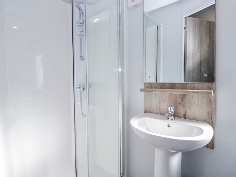A bathroom with a shower and a sink at Willerby High End Brand S6 (on Coniston) St Bees