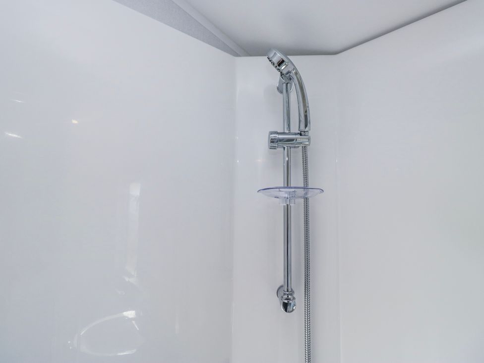 A shower with a showerhead and hose at Willerby High End Brand S6 on Coniston St Bees