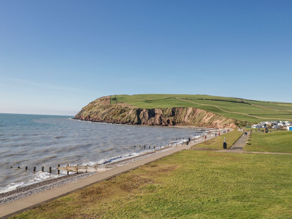 A view of cliffs and the sea with a pathway and people at Willerby High End Brand S6 (on Coniston) St Bees