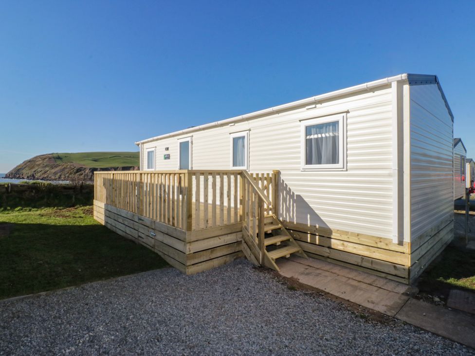 A mobile home with a wooden deck at Swift Brand (HOTEL SIDE) S4 St Bees