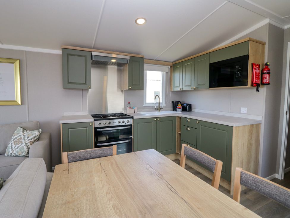 A kitchen with a stove and sink at The Swift in St Bees
