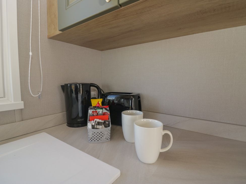 A kitchen counter with a kettle, toaster, and two mugs at The Swift in St Bees