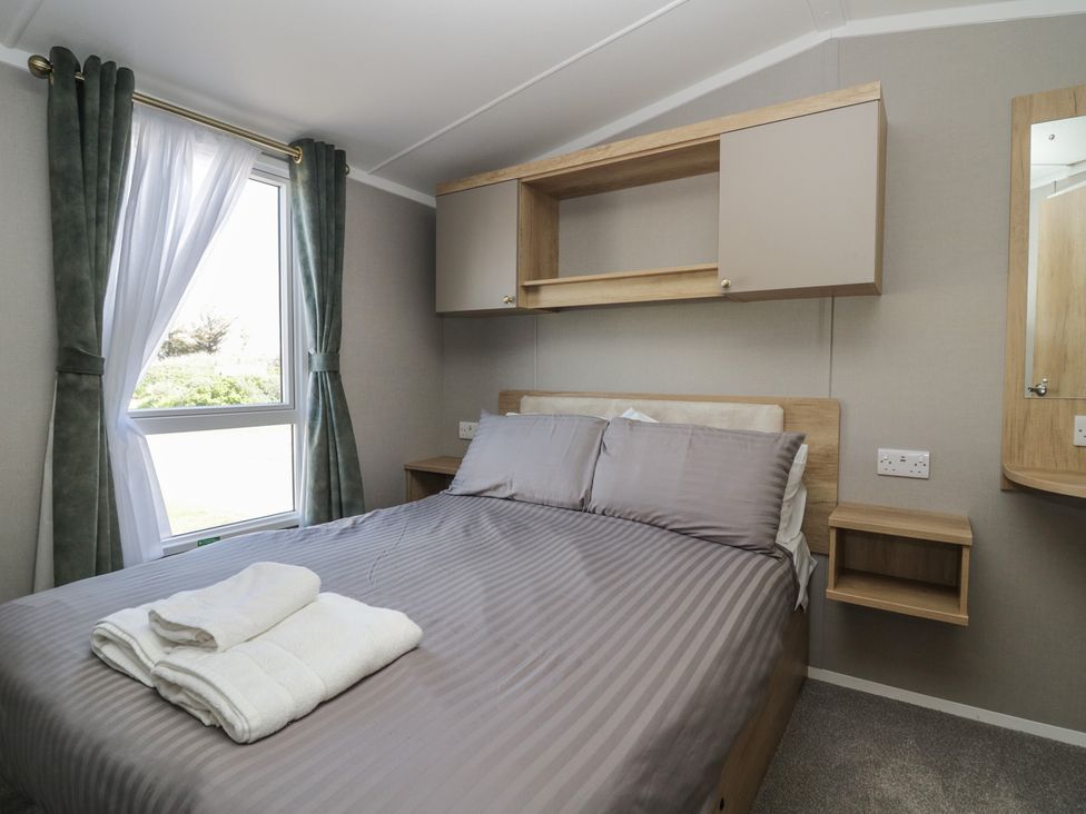 A bedroom with a bed and window at The Swift in St Bees