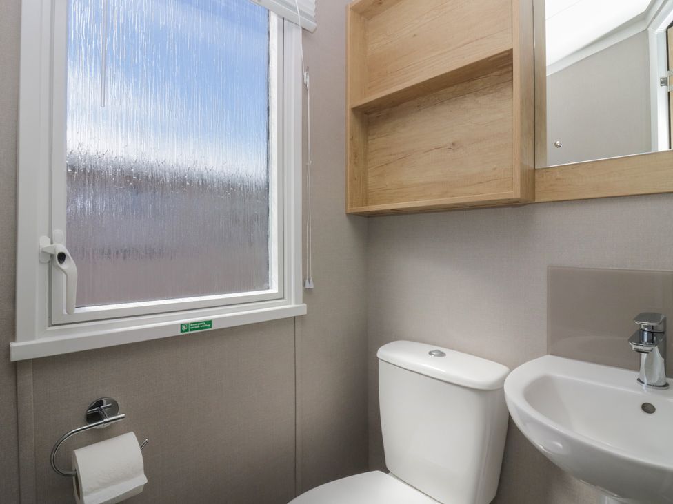 A bathroom with a toilet and sink at The Swift in St Bees