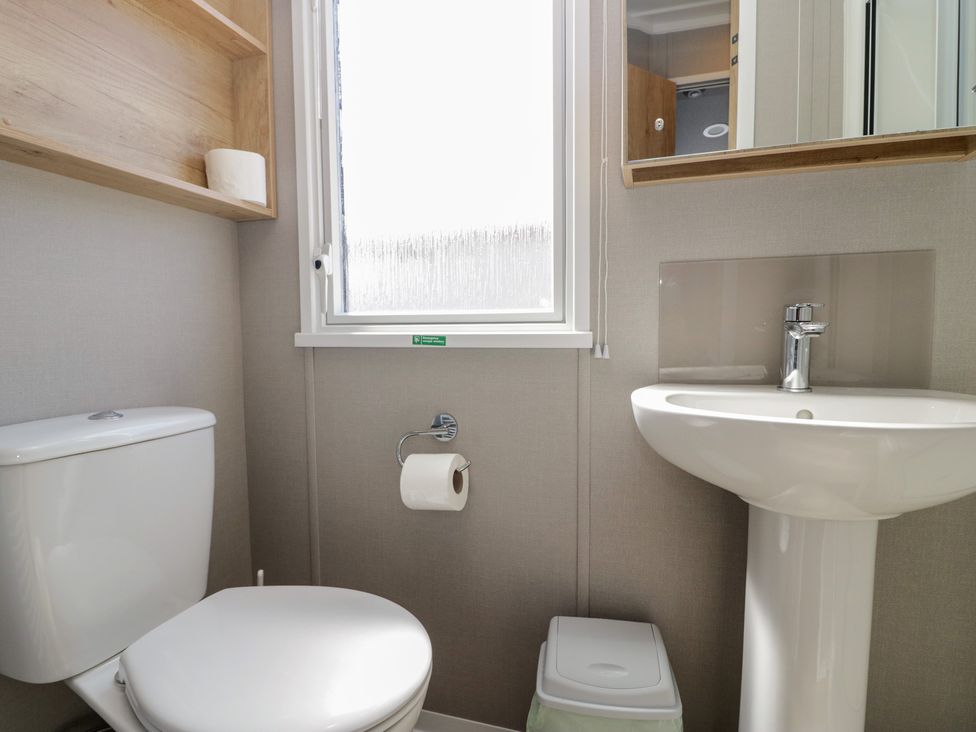 A bathroom with a toilet and sink at The Swift in St Bees