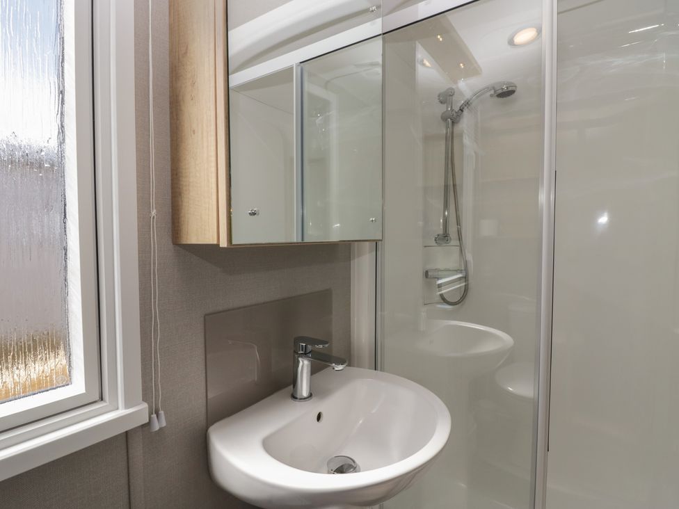 A bathroom with a sink and a shower at The Swift St Bees