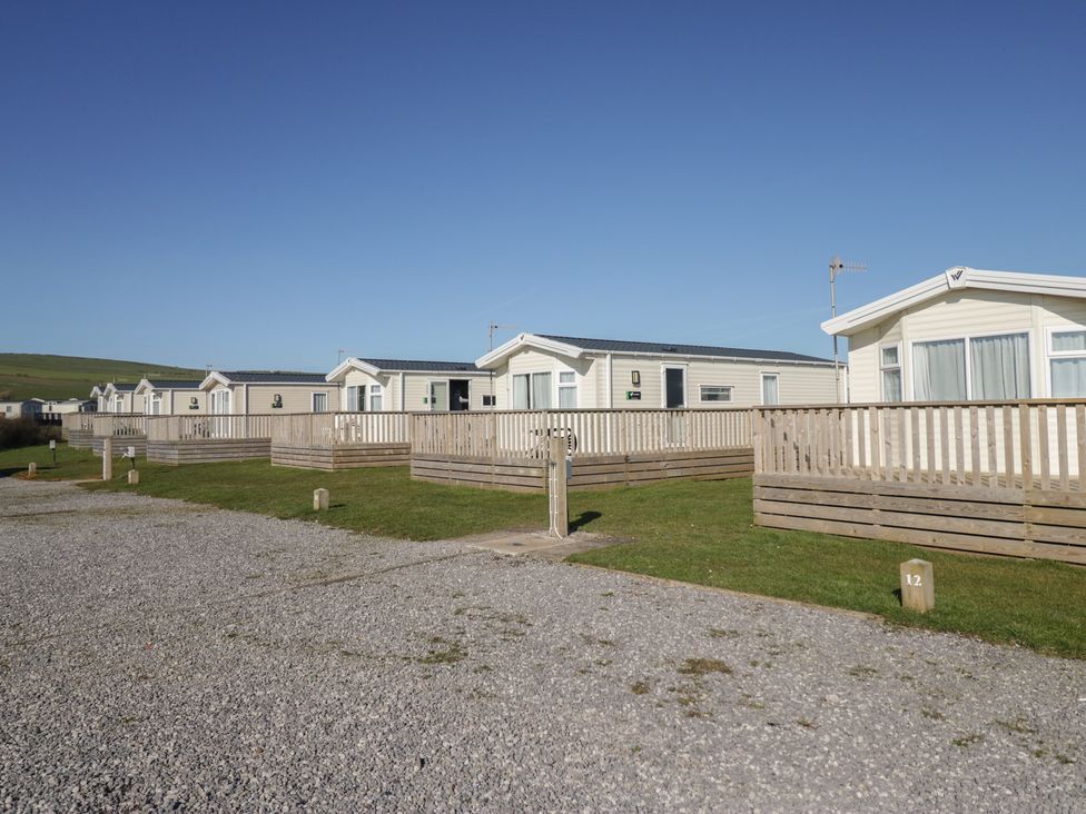 Mobile homes with wooden fencing in outdoor area at Swift Brand (3 Bed) (on Coniston) St Bees