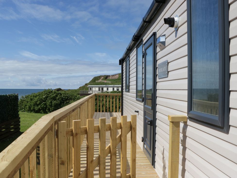 A house with a wooden deck and sea view at The Plover in St Bees
