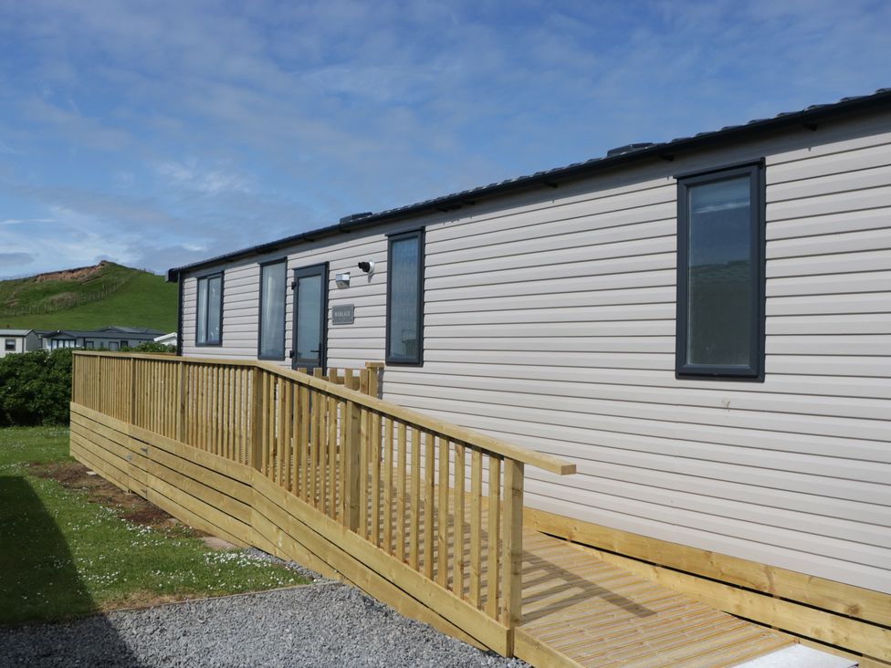 A mobile home with a deck and ramp at The Plover in St Bees
