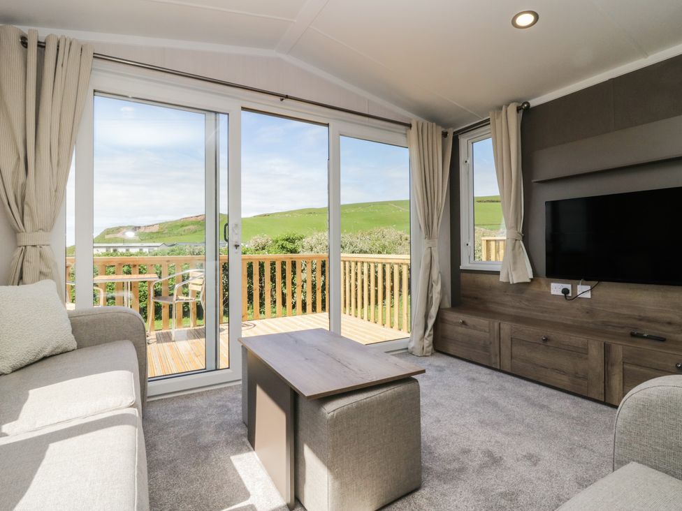 A living room with sofa and television at The Plover in St Bees