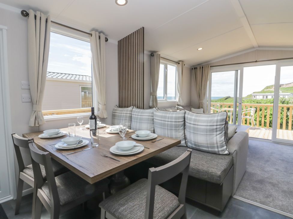 A dining area with a table and chairs at The Plover in St Bees