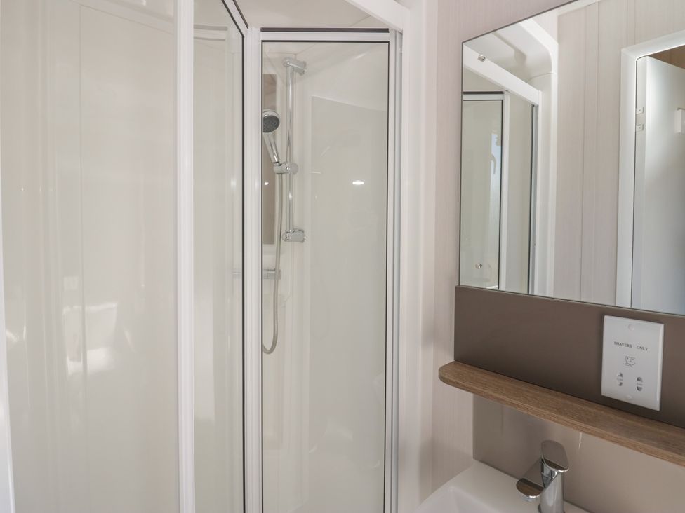 A bathroom with a shower and sink at The Plover in St Bees