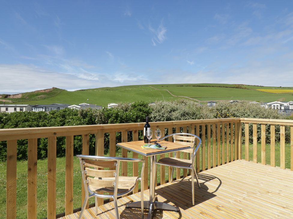 An outdoor seating area with a table and chairs at The Plover in St Bees