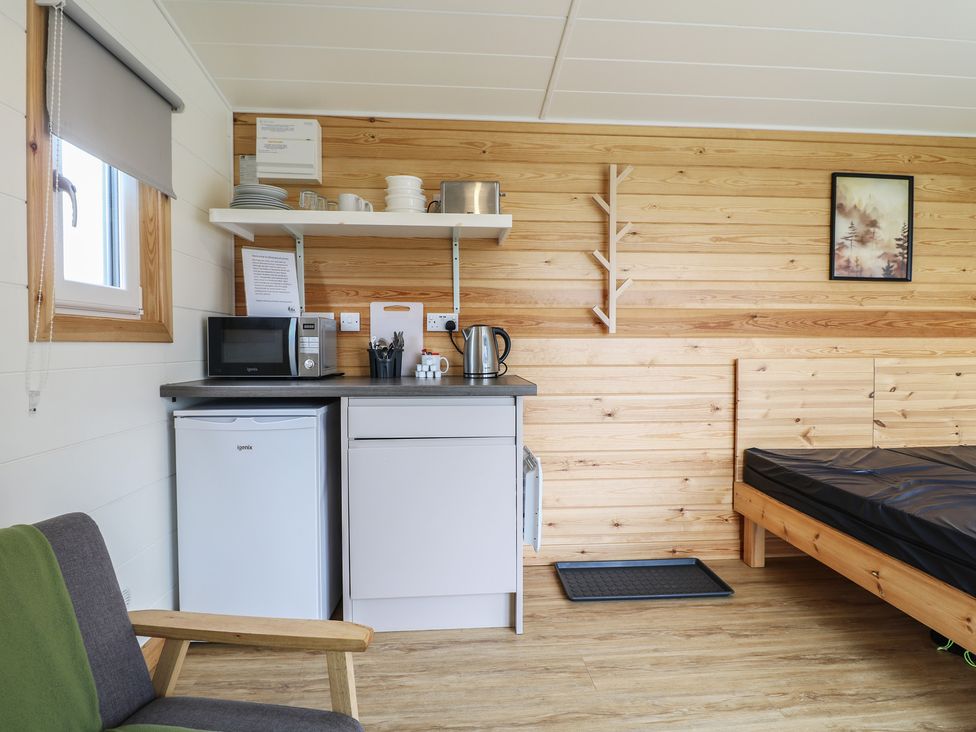 A snug with a refrigerator and microwave at Sherwood - Cosy Pod 1