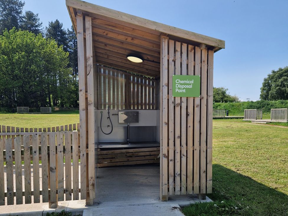 A chemical disposal point with a sink and hose in an outdoor area at Sherwood - Cosy Pod 1