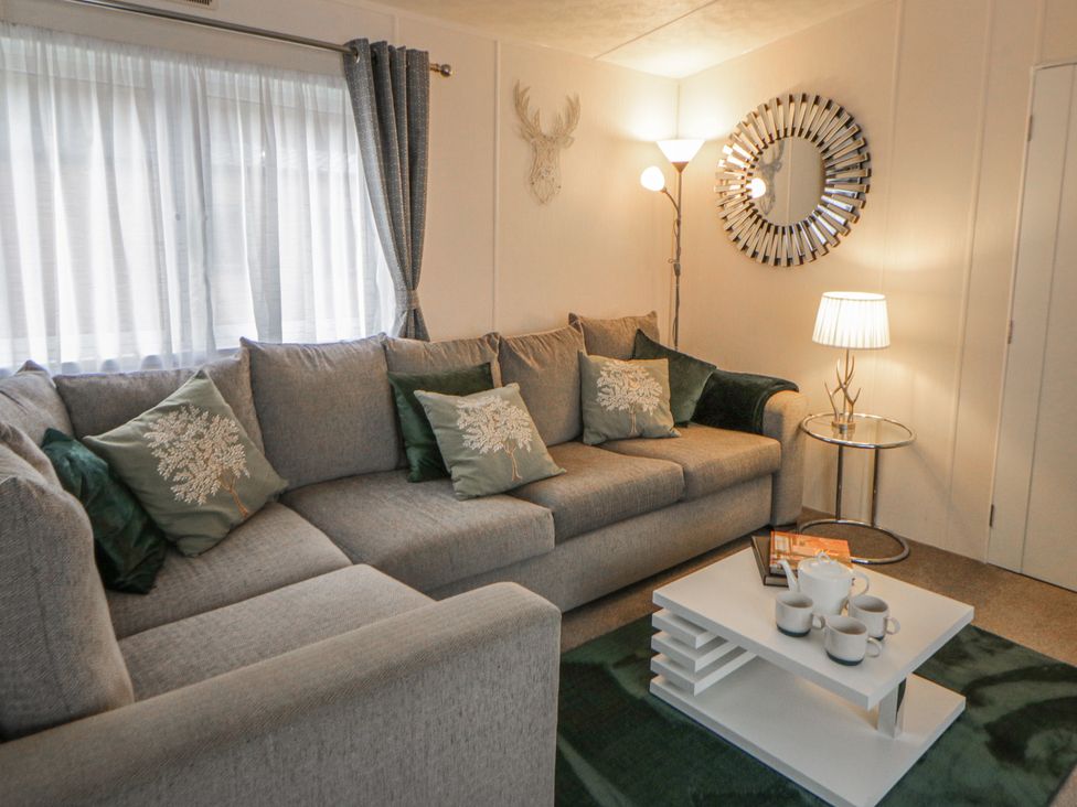 A living room with a sofa and coffee table at The Ridgeway in New Quay