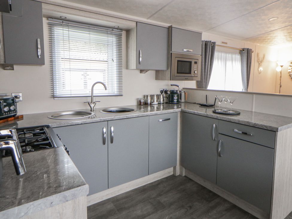 A kitchen with a stove and sink at The Ridgeway in New Quay