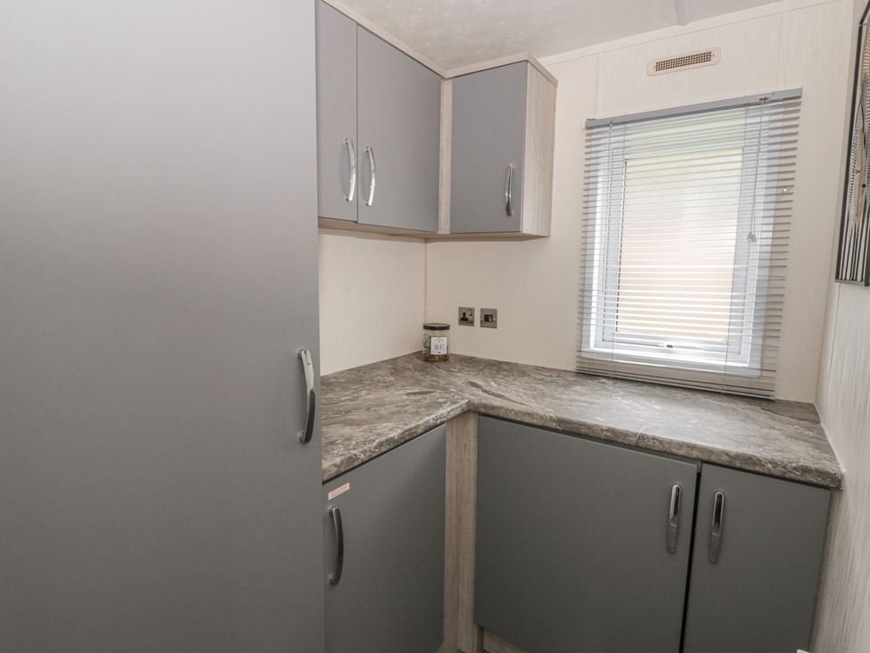 A kitchen with gray cabinets and a countertop at The Ridgeway in New Quay