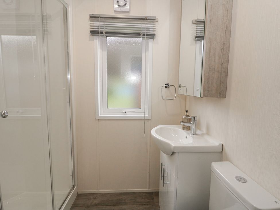 A bathroom with a shower, sink, and toilet at The Ridgeway in New Quay