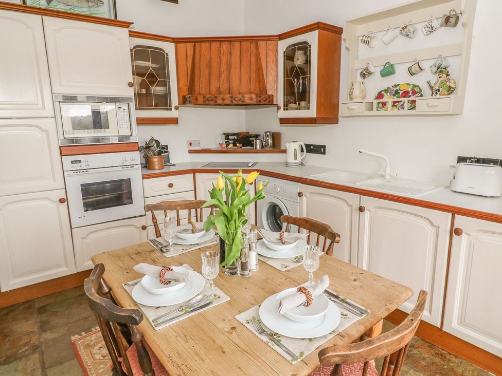 A kitchen with a dining table set at The Bothy in Leyburn