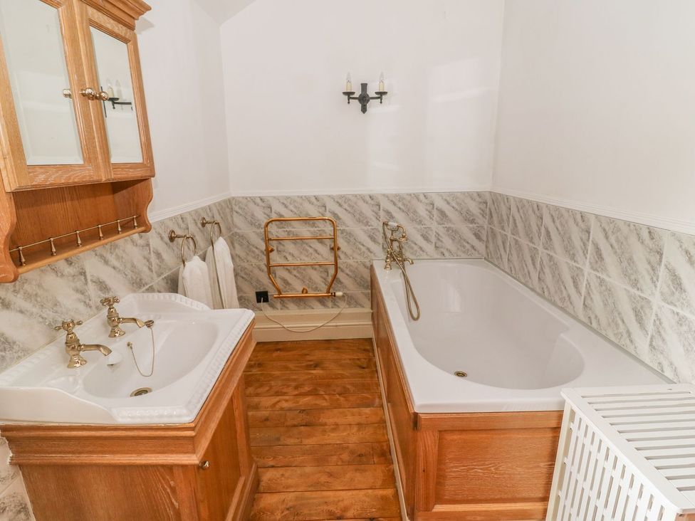 A bathroom with a bathtub and sink at The Bothy in Leyburn