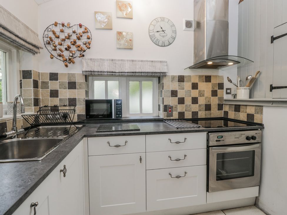 A kitchen with a sink and appliances at The Dove Cot in Ambleside
