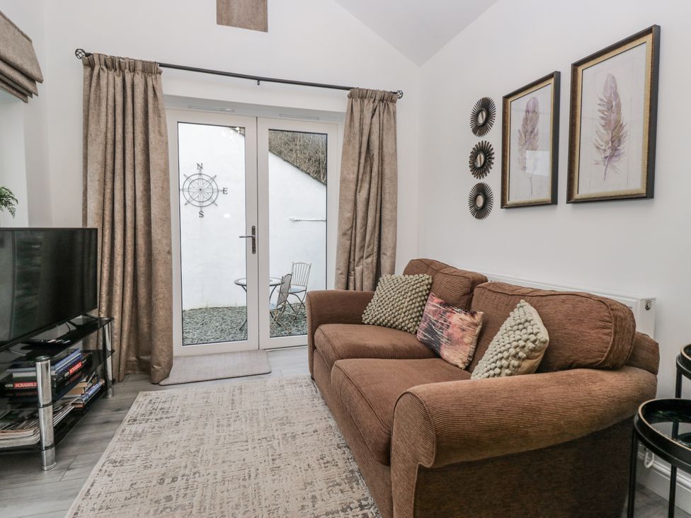 A living room with a sofa and television at The Dove Cot in Ambleside